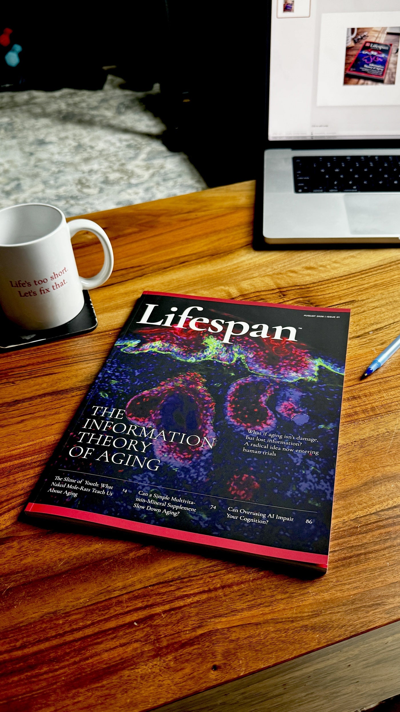 The inaugural print issue of Lifespan magazine, August 2026, lying on a wooden desk beside a mug and pen