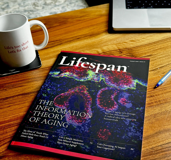 The August 2026 inaugural issue of Lifespan magazine on a wooden desk, beside a mug reading Life's too short. Let's fix that.